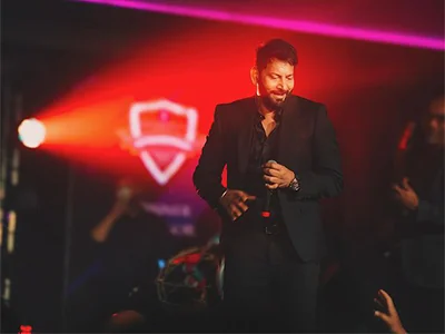 Jasbir Jassi performing live under red stage lighting